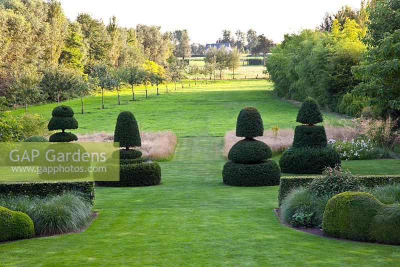 Large lawns surrounded by topiary and mature trees
