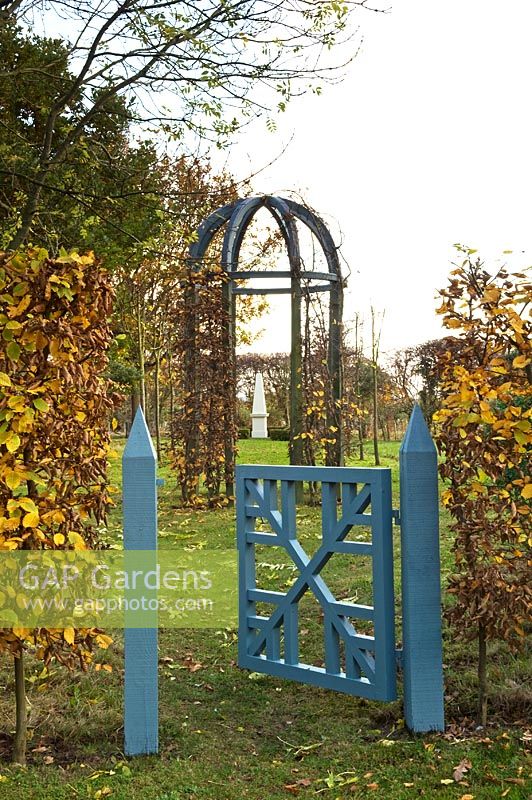 Painted gate leading to gazebo - Silverstone Farm, Norfolk