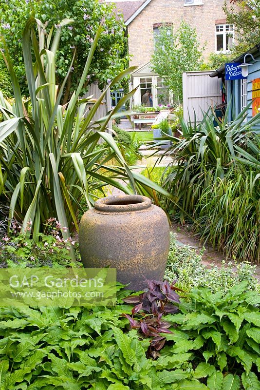 Clay urn used as a focal point - Helen Riches' Garden, Essex 
