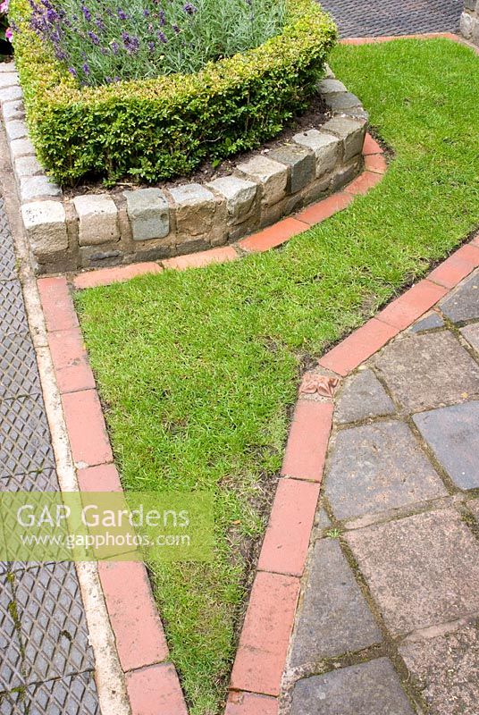Detail of lawn edging and path made from reclaimed Southport paviours, platform station tiles and red brick, raised bed edged with Buxus - Box hedge and Lavandula - Brocklebank Road, Southport, Lancashire NGS 

