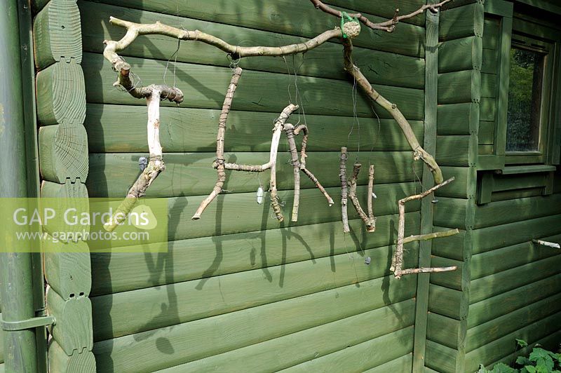Branches spelling out the word Thrive which is a small national charity that uses gardening to change the lives of disabled people. This was taken at their garden project in Battersea Park, London, UK