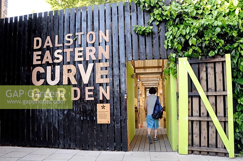 Man entering Dalston Eastern Curve Garden, an urban community garden in the London Borough of Hackney 