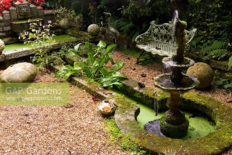 Ponds and rill in the Sunken Garden with tiered water feature and various shade tolerant plants including ferns. The Secret Garden at Serles House, Wimborne, Dorset, UK