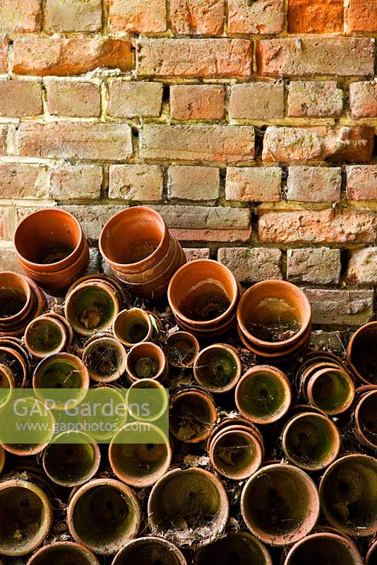 Pots stacked against brick wall - Holbeach Hurn, Lincolnshire, UK 
