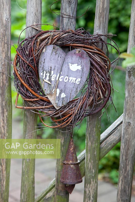 Rustic 'Welcome' sign and rusty bell on wooden gate - Scheper Town Garden 