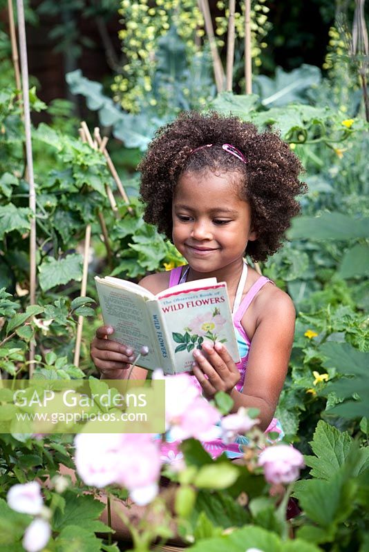 Young girl reading wildflowers book