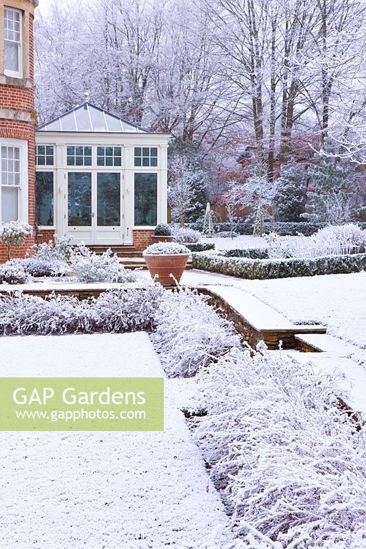 Formal town garden covered in snow, Oxford, UK.
