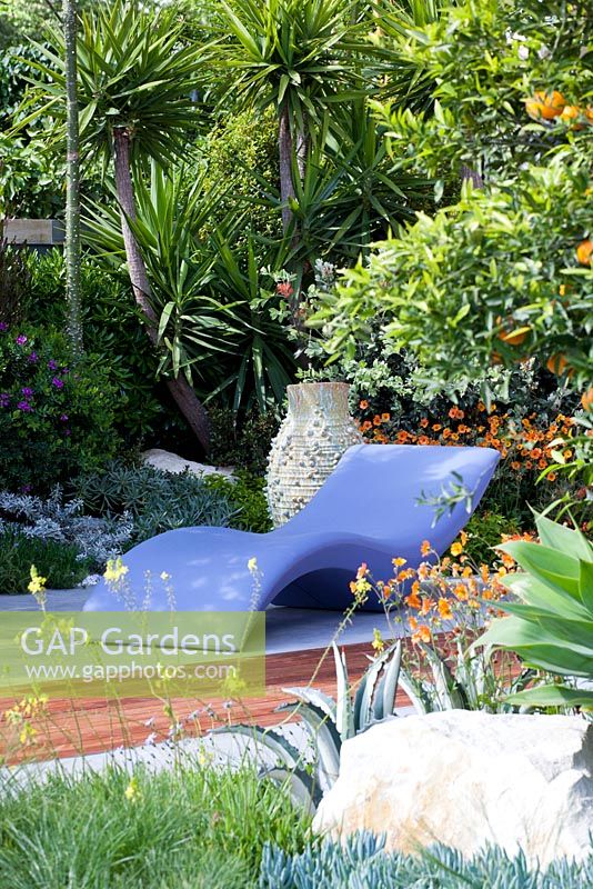 Modern recliner in contemporary Mediterranean style garden 