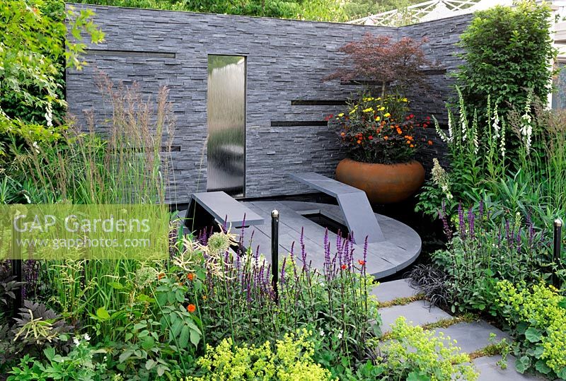 Urban garden with solar panels fitted in slate wall