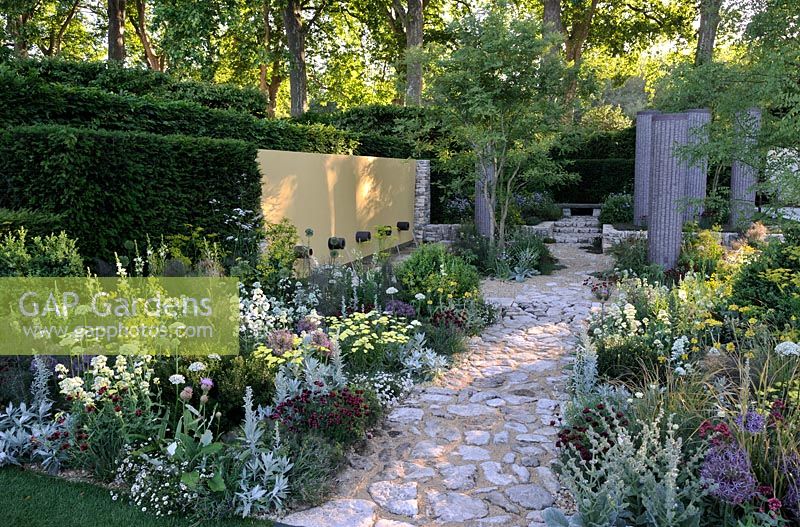 Extensive Perennial planting with water feature and reclaimed Cotswold stone Path