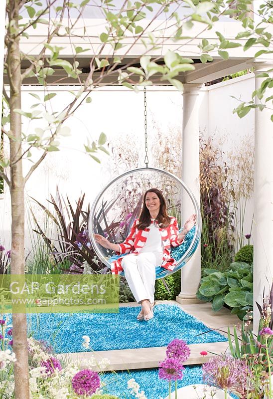 Rachel de Thame in a swing seat above blue carpet 'lawn' - 'The Chilstone Garden' - Silver Medal Winner, RHS Chelsea Flower Show 2011
 