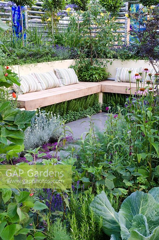 Edible garden surrounded a wooden bench, underplanted with herbs - 'The Deptford Project - An Urban Harvest', Silver Medal Winner, RHS Hampton Court Flower Show 2011