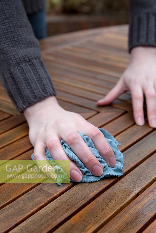 Wiping down, cleaning, patio table surface