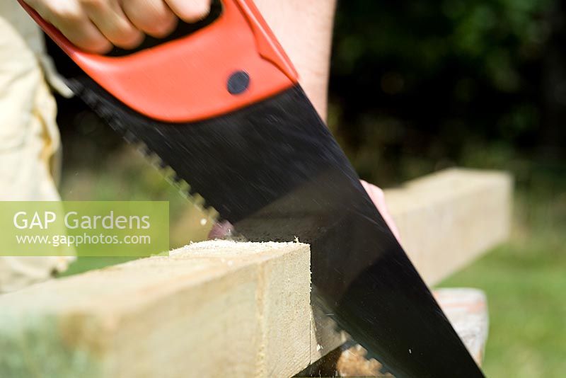 step by step, making a raised bed - cutting wood uprights