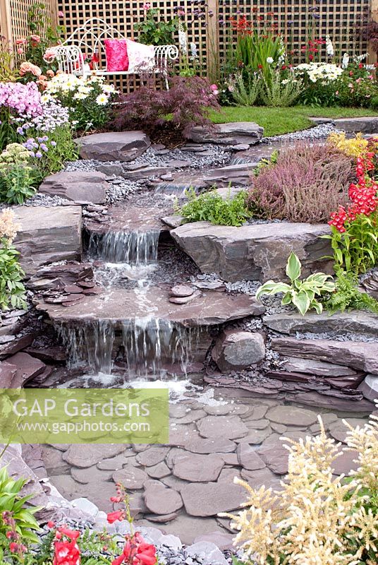 Stream cascading down rockery to pool in the 'Vintage Rose' garden by Chris Ashcroft Landscapes - Southport Flower Show 2011