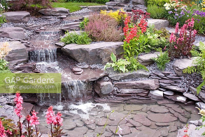 Stream cascading down rockery to pool in the 'Vintage Rose' garden by Chris Ashcroft Landscapes - Southport Flower Show 2011
