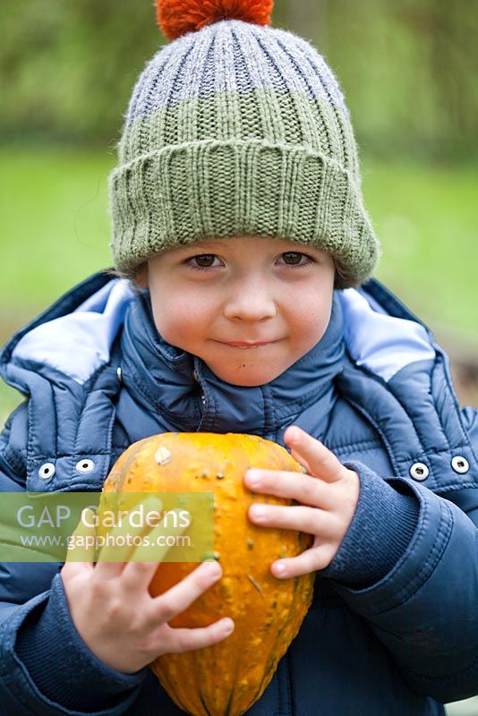 Boy holding Pumpkin.