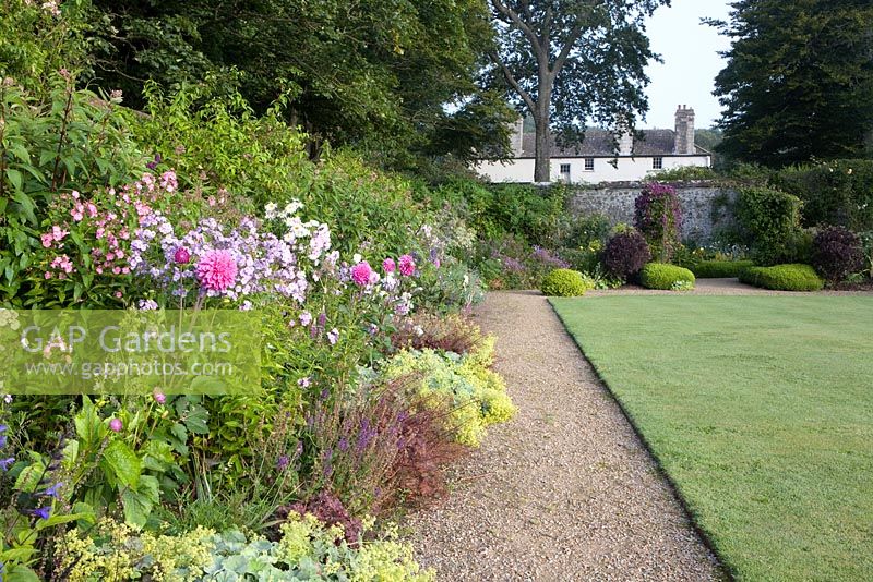 Walled  gardens and herbaceous borders lining paths - Bonython Estate Gardens, Cornwall
 