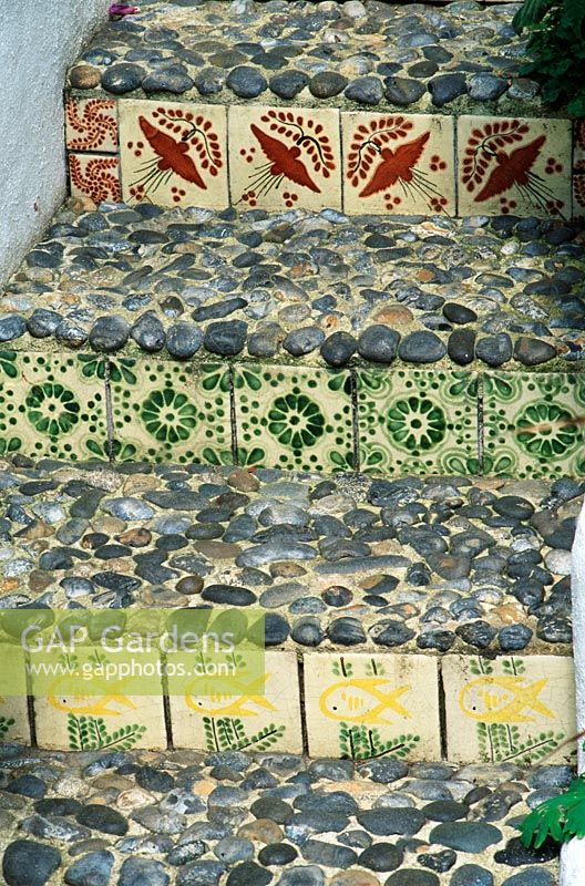 Steps with decorative tiles and pebbles