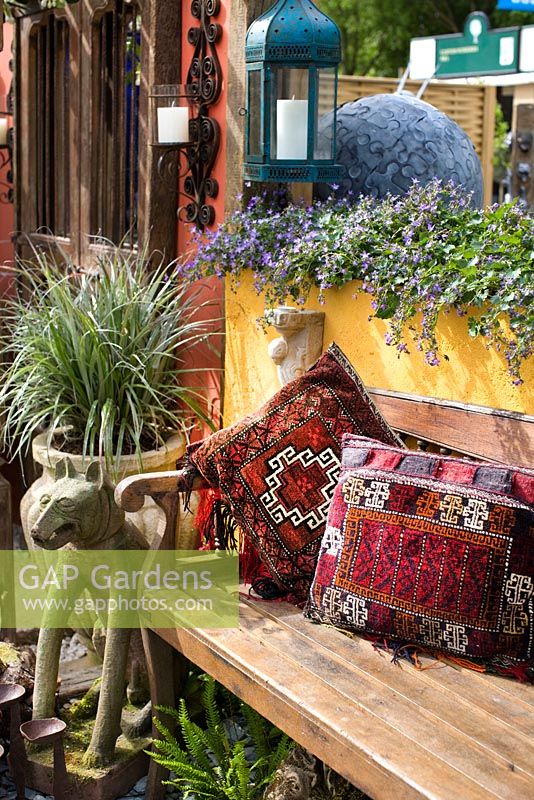Wooden bench with decorative pillows - RHS Chelsea Flower Show 2011