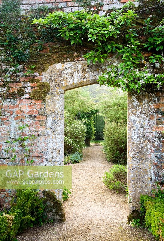 Doorway in brick wall between Vegetable Garden and Walled Garden - Rousham House, Bicester, Oxon, UK