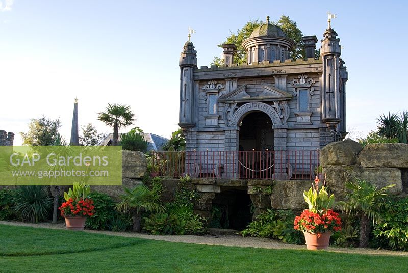 Oberon's Palace, a copy in oak of an Inigo Jones' design for a royal masque performed in Whitehall in 1611, recreated in the Collector Earl's Garden, designed by Julian and Isabel Bannerman. It sits atop a rockwork mountain and is surrounded by strongly architectural planting including palms, fatsias and cordylines.