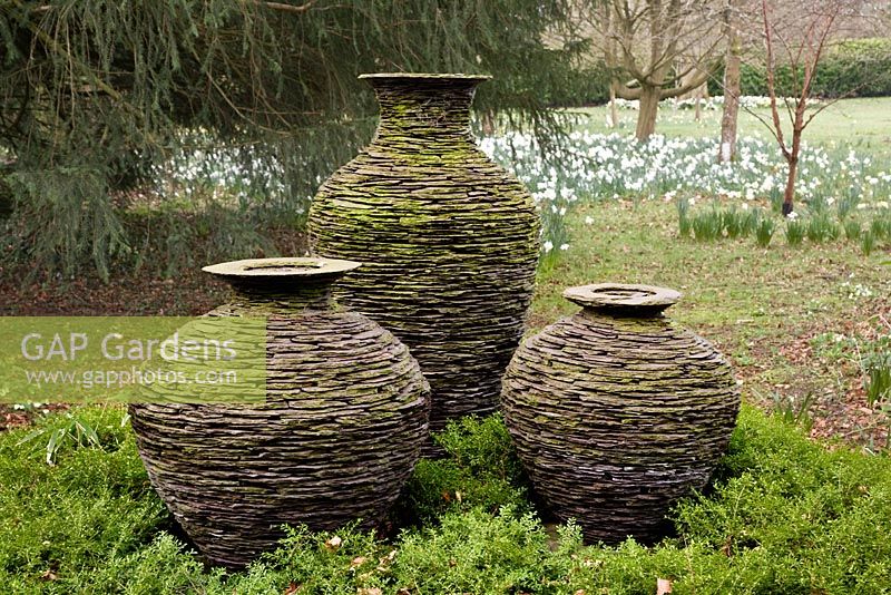 Pots made of Welsh slate, created with similar look to stone walls. The pots are In the meadow, Highgrove Garden, March 2008. 