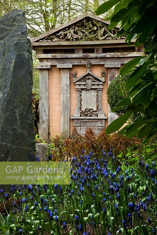 Spring flowers and one of the two temples made from green oak in the Stumpery. Highgrove Garden, April 2010