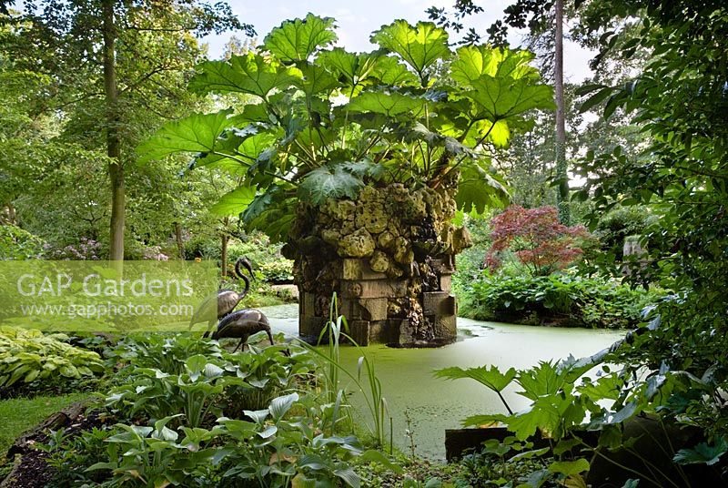 The Water Feature with Gunnera - Giant South American Rhubarb in the Stumpery, Highgrove August 2007. The water feature is made of Hereford red sandstone and Spanish limestone. 
