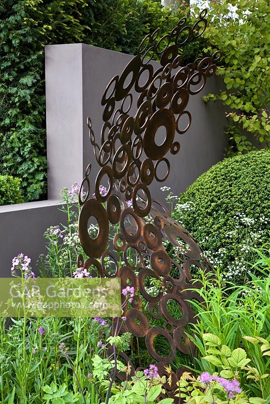 The M & G Garden. Focal point is an energy wave sculpture made from copper rings. 