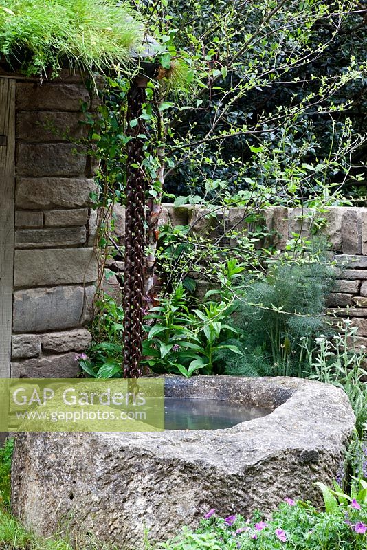 Artisan Gardens - Naturally Dry a William Wordsworth inspired garden. Water-chain leads from roof into old well. Drought tolerant plants include silver birch, Salvia 'Twilight Serenade', geraniums, Asplenium scolopendrium, Achillea and Foeniculum vulgare 'Giant Bronze'