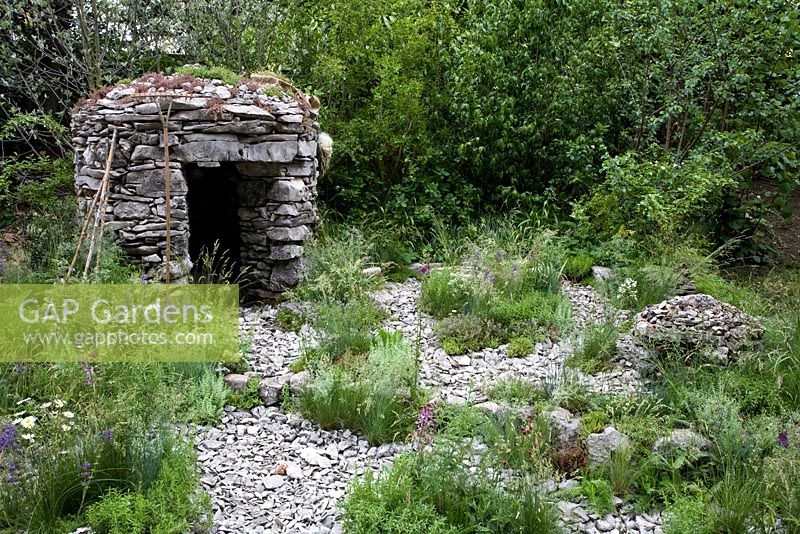 A garden set 100 years ago in the Slovenian Karst region. Features a stone-built hideaway, a shelter for child shepherds. Dry meadow planting - RHS Chelsea Flower Show 2012