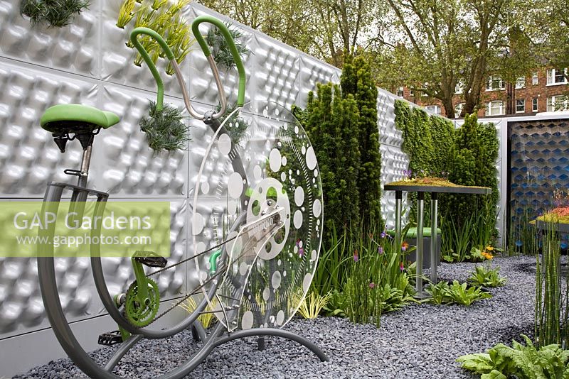 Garden designed to process and recycle waste. By using the excercise bike, waste is pumped to the top of the modular living walls and filtering units - The Soft machine garden, RHS Chelsea flower show 2012