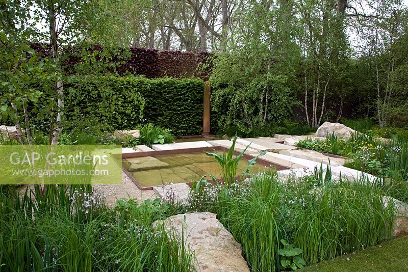 The Telegraph Garden, Gold Medal winner, RHS Chelsea Flower Show 2012. Perennials, rushes, grasses and meadow flowers around a pattern of pools in Chilmark limestone. Copper detailing
