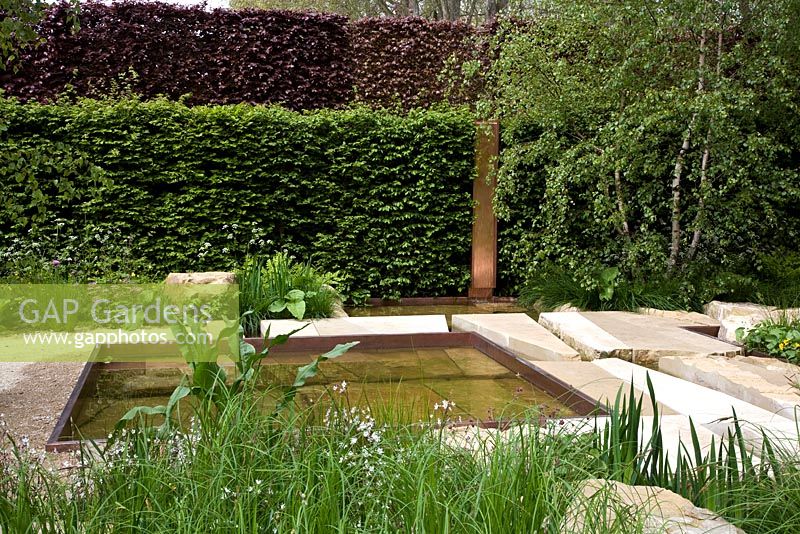 The Telegraph Garden, Gold Medal winner, RHS Chelsea Flower Show 2012. Perennials, rushes, grasses and meadow flowers around a pattern of pools in Chilmark limestone. Copper detailing
 
