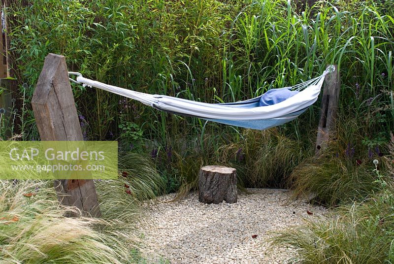 Hammock in small gravel area surrounded by ornamental grasses in the 'One Man Went To Mow' garden, RHS Tatton Flower Show 2012