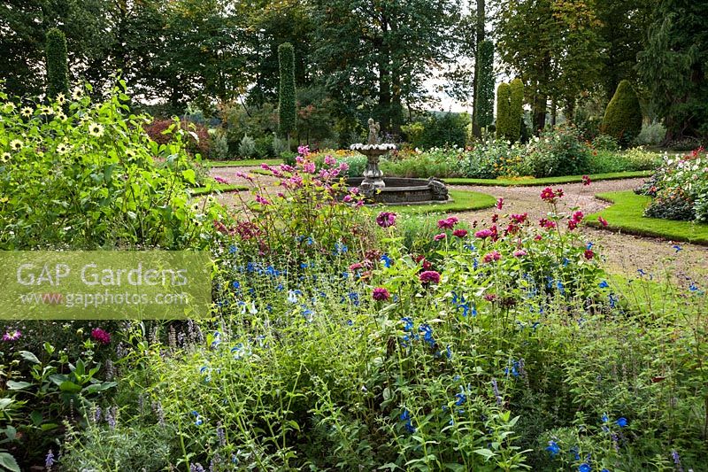 Fountain garden with beds full of salvias, zinnias, calendulas and other late season flowering plants