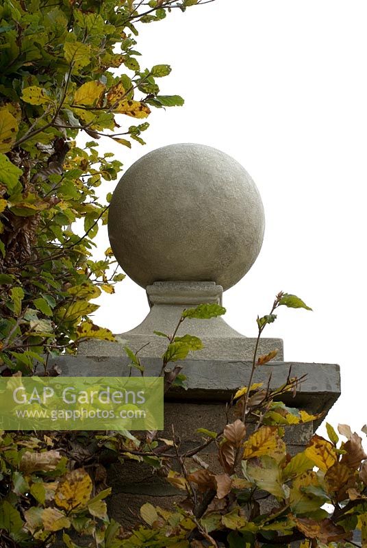 Outside light made of resin disguised as a stone ball on top of a pillar, designed by Joanna Wallis 
