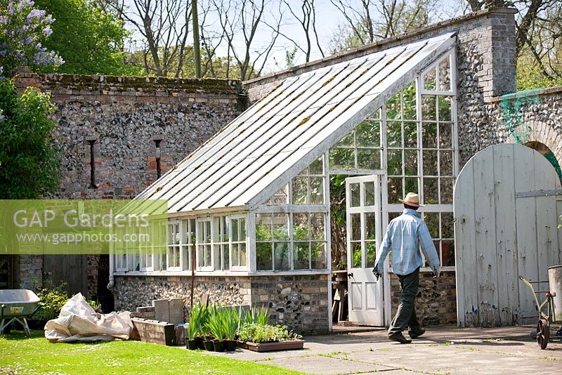 Lean-to glasshouse on the outside wall of the walled garden at Wretham Lodge, Norfolk