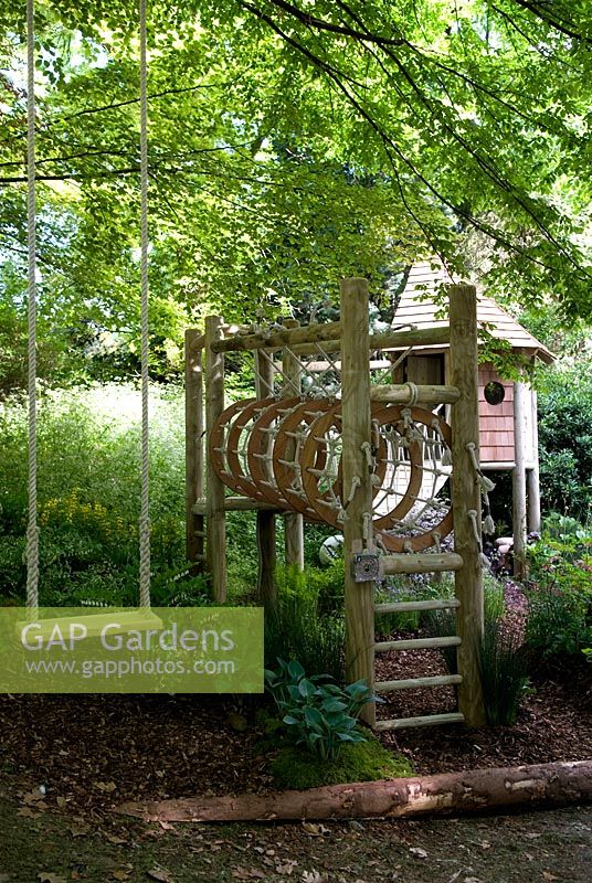 Childrens' play area in garden - swing, climbing frame and playhouse
