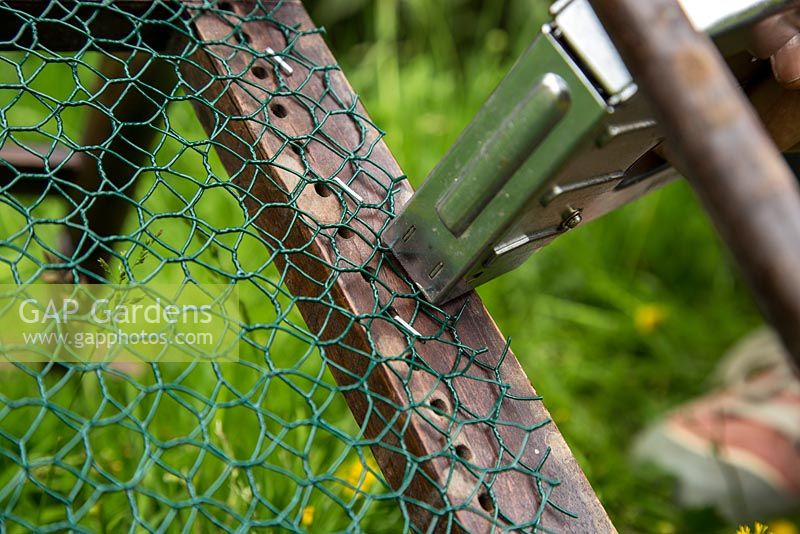 Step by Step -  Creating a turf chair - stapling wire to chair to hold turf in place