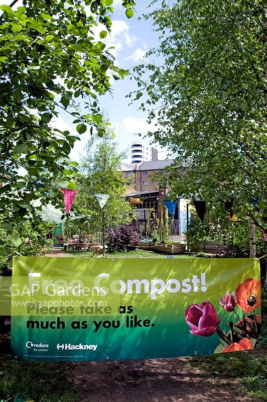 Banner saying Free Compost, Please take as much as you like. Dalston Eastern Curve Garden, an urban community garden, London Borough of Hackney, UK