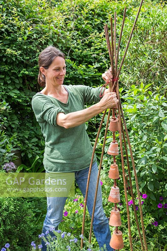 Step by step -  Making a decoration from small terracotta pots to hang inside hazel wigwam - adding the decoration to the wigwam 
