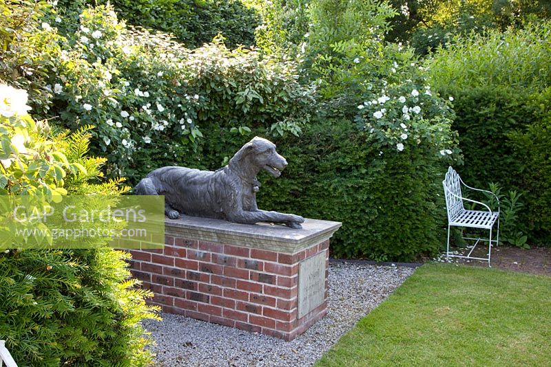 Monument for a dog in country garden 