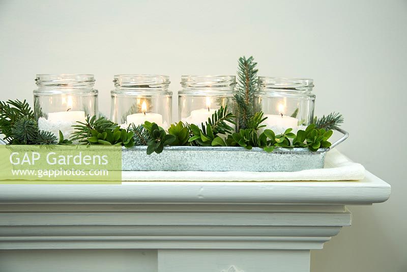Christmas candle decorations arranged with christmas greenery