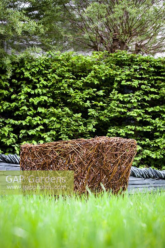 Woven willow sculpture in the grass. 