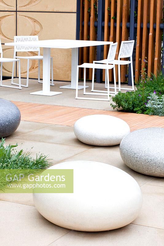 The Brewin Dolphin Garden - contemporary garden with polished concrete boulders table and chairs