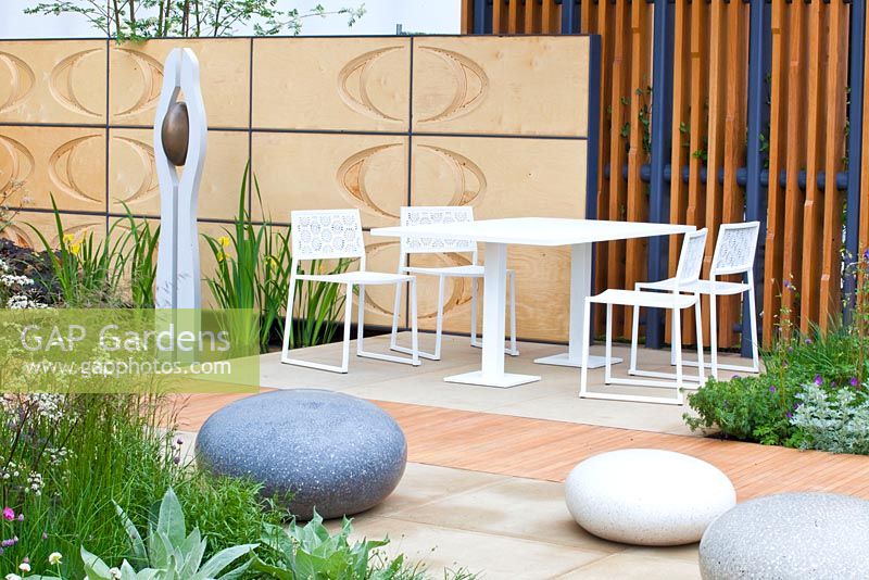 The Brewin Dolphin Garden, contemporary garden with polished concrete boulders, table and chairs