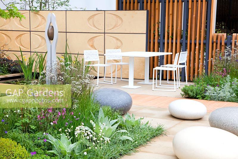 The Brewin Dolphin Garden -  contemporary garden with polished concrete boulders, water bassin, sculpture, table and chairs