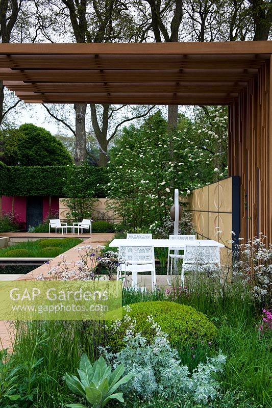 Brewin Dolphin garden  - RHS Chelsea Flower Show 2013 - Large wooden slatted shade shelter with chairs and table 